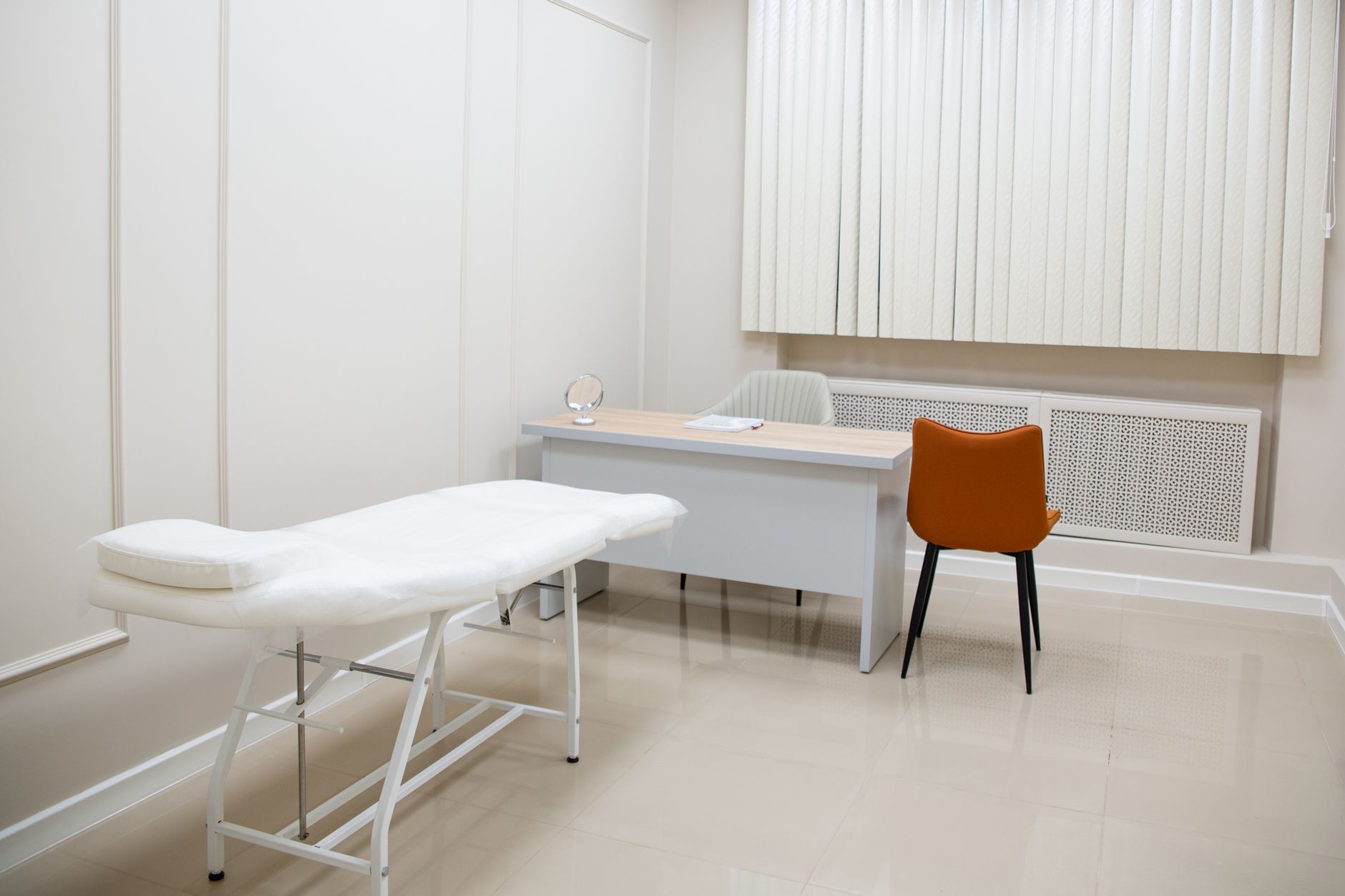A medical exam room with a treatment chair