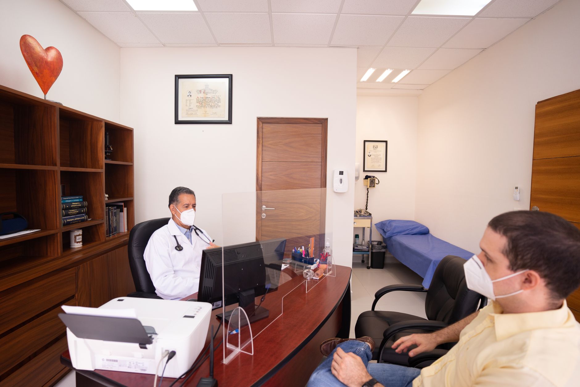 A patient talking with a doctor across a desk